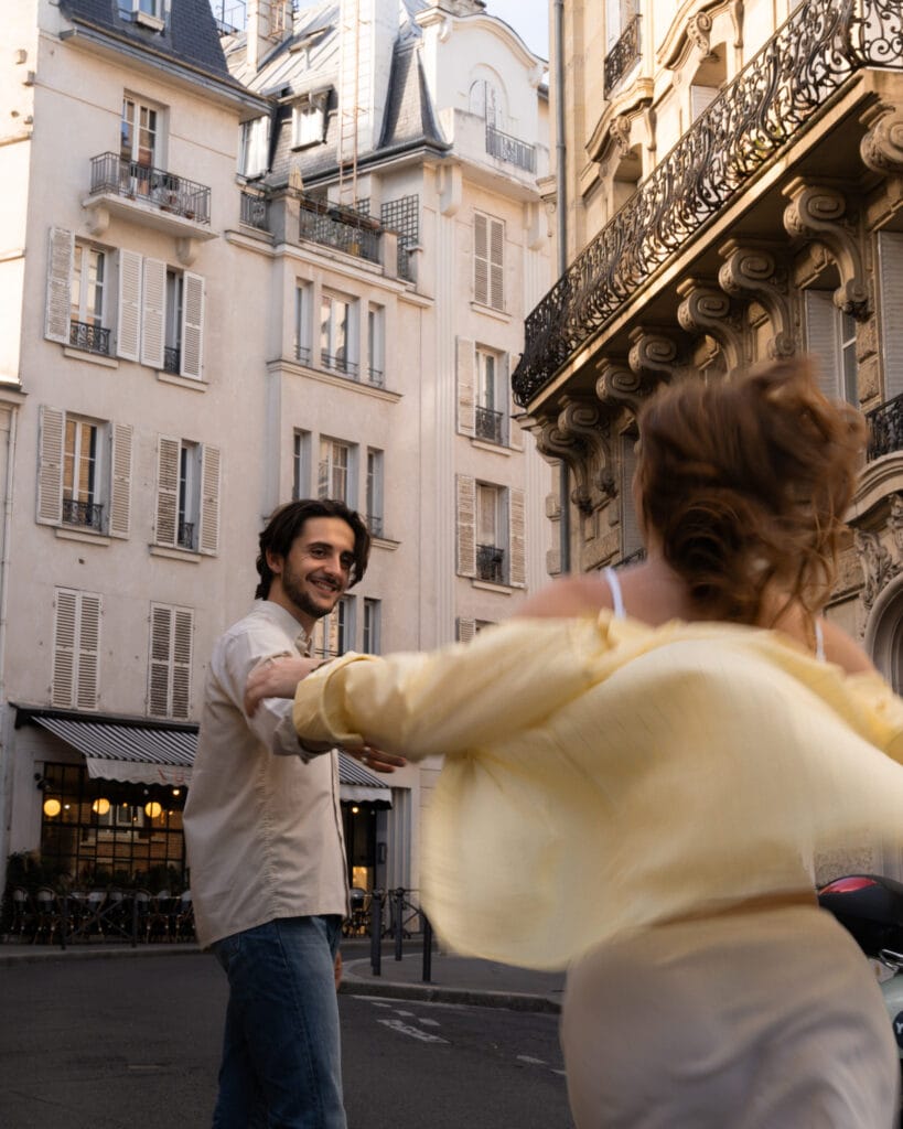 couple running through streets in paris