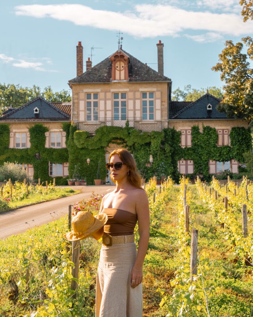 girl stands outside country chateau in burgundy france wine region france travel