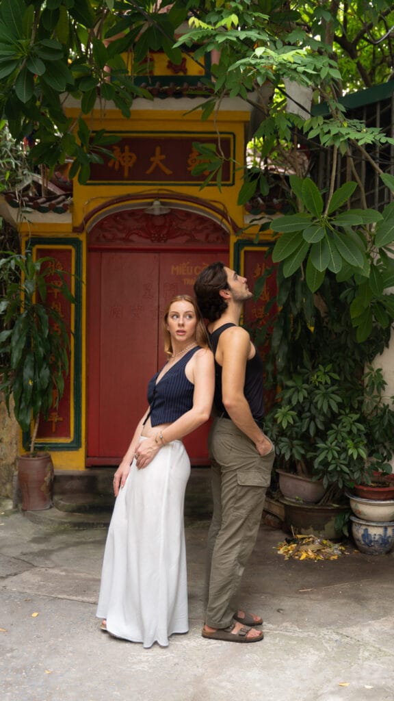 couple stands on street in Hanoi