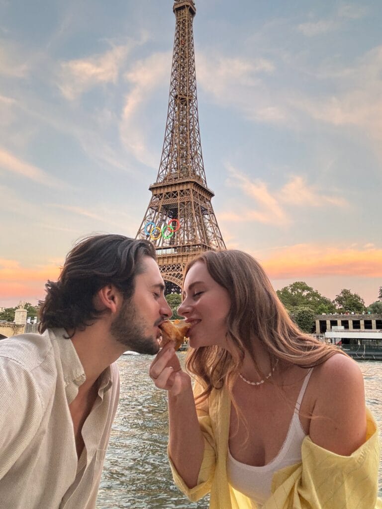 couple under the eiffel tower during paris olympics