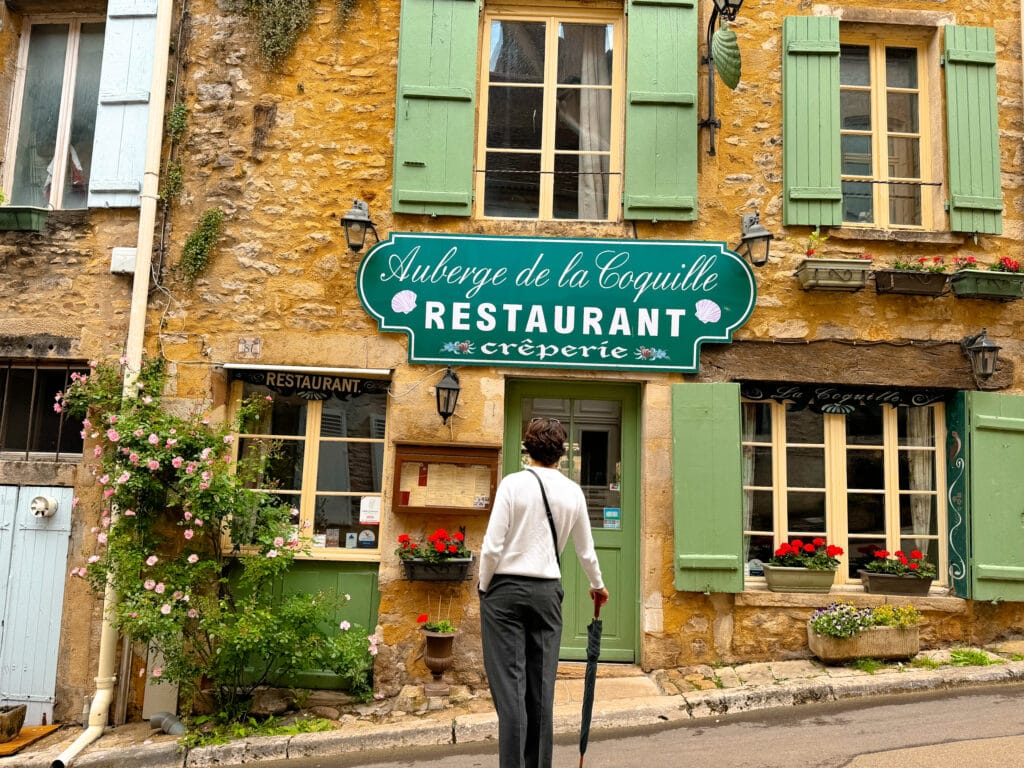 creperie on a sloping street in medieval french village france travel