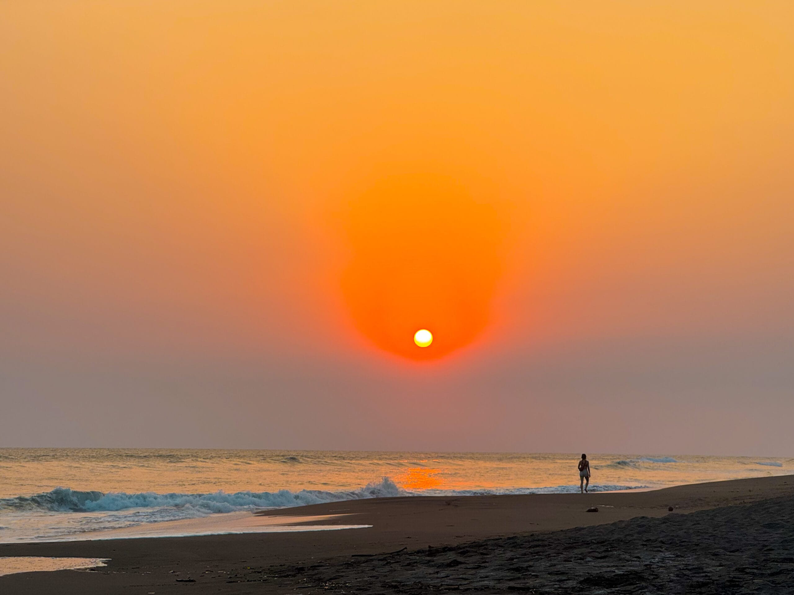 guatemala travel sunset over black volcanic beach at El Paredon