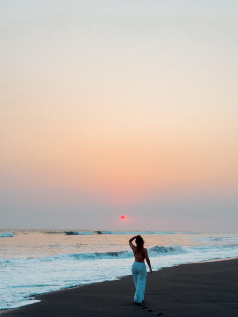 guatemala travel girl walks on the beach at sunset in el paredon