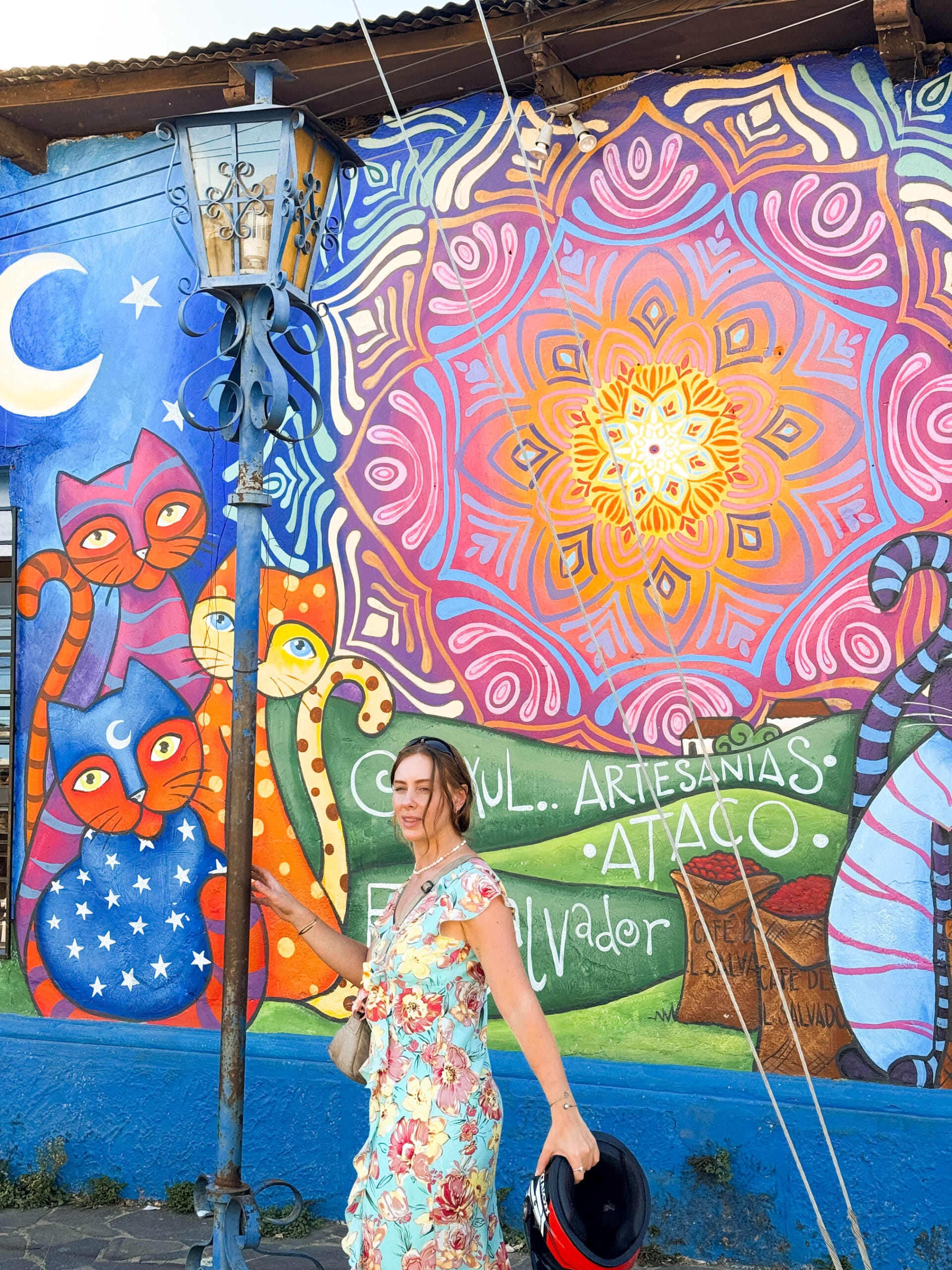 girl walks down colourful painted street in el salvador