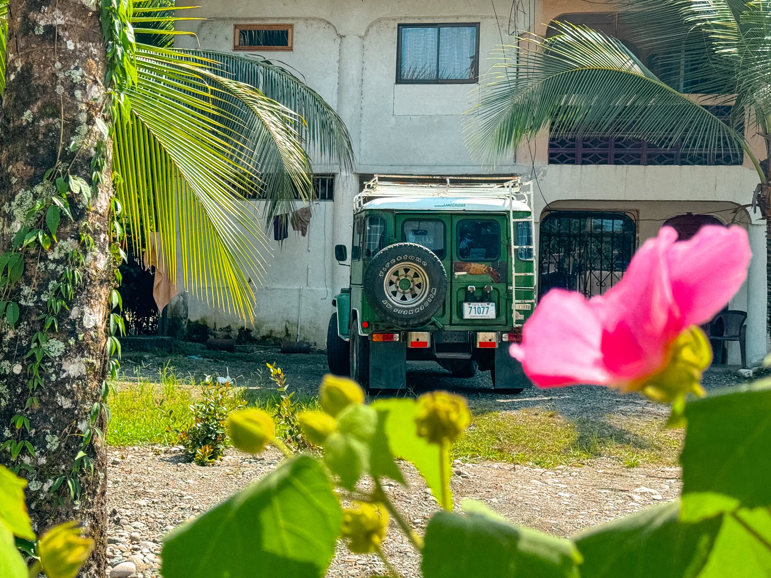 costa rica travel land cruiser behind jungle trees in puerto viejo