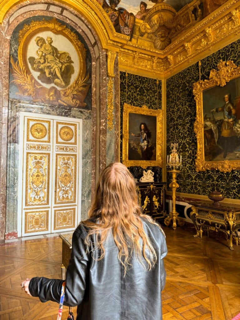 girl looking at gilded ceiling versailles chateau interior france travel