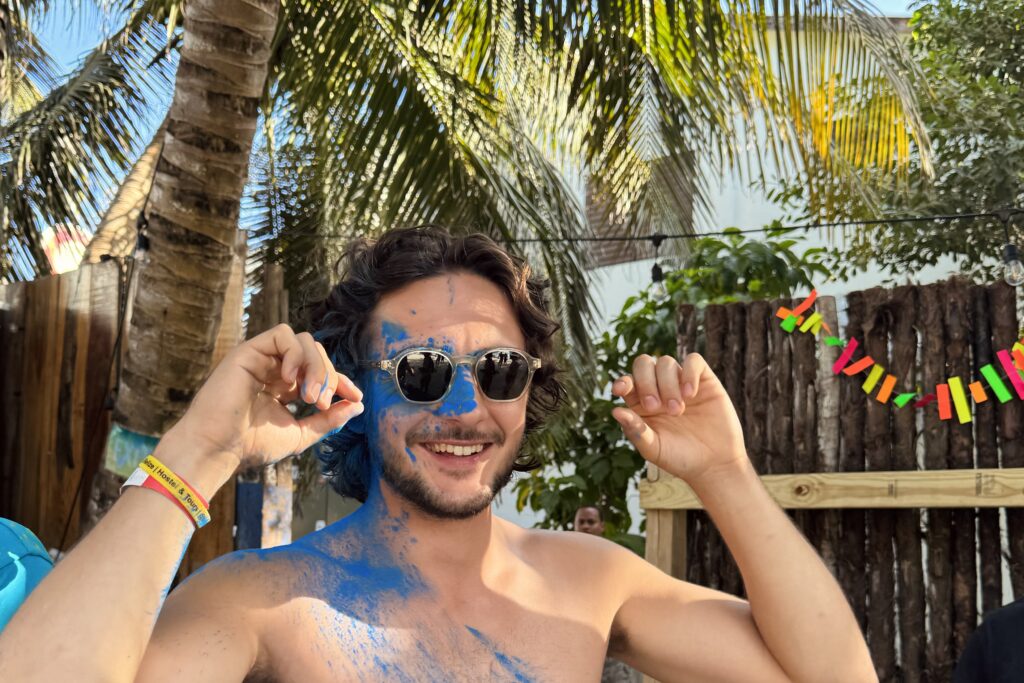 man with coloured paint at tropical party