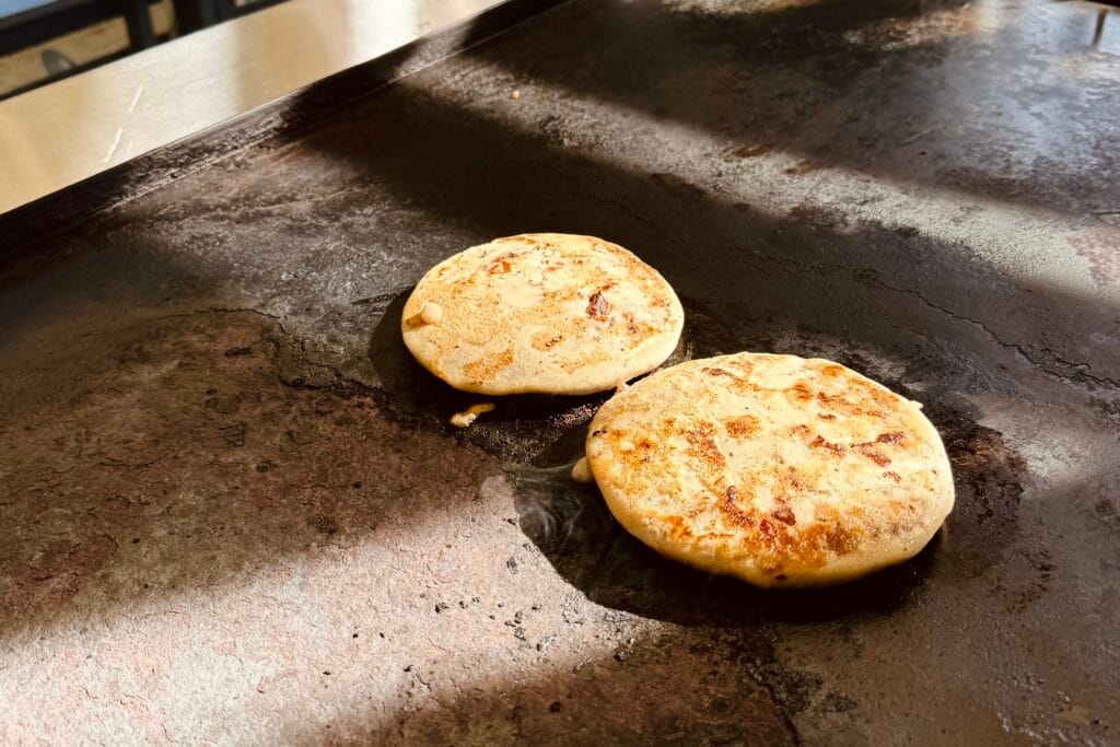 pupusas cooking on the plancha